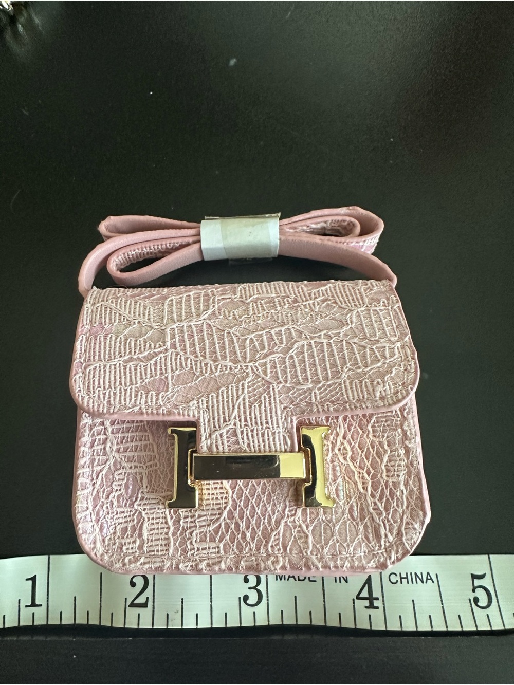 Bag charm/earbud holder. Pink lace textured mini “bag”. New